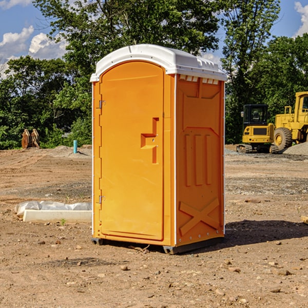 what is the cost difference between standard and deluxe portable restroom rentals in Rush